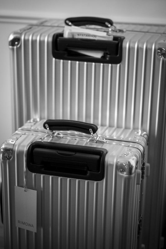 A couple of silver suitcases sitting next to each other